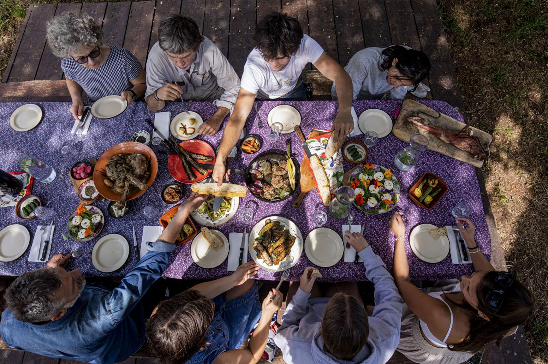 The Winkler family gathered around the table at Stancija Kumparička, sharing a farm-to-table meal