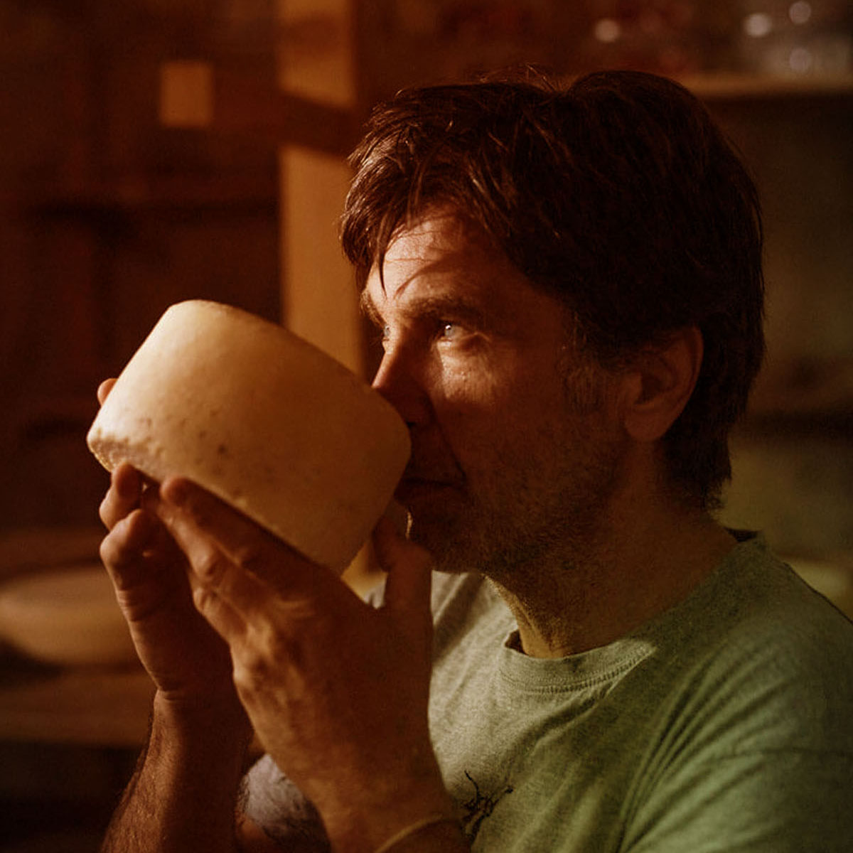 Aleš Winkler smelling a wheel of aged Kumparička cheese in the dairy